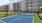 a tennis court in front of a building